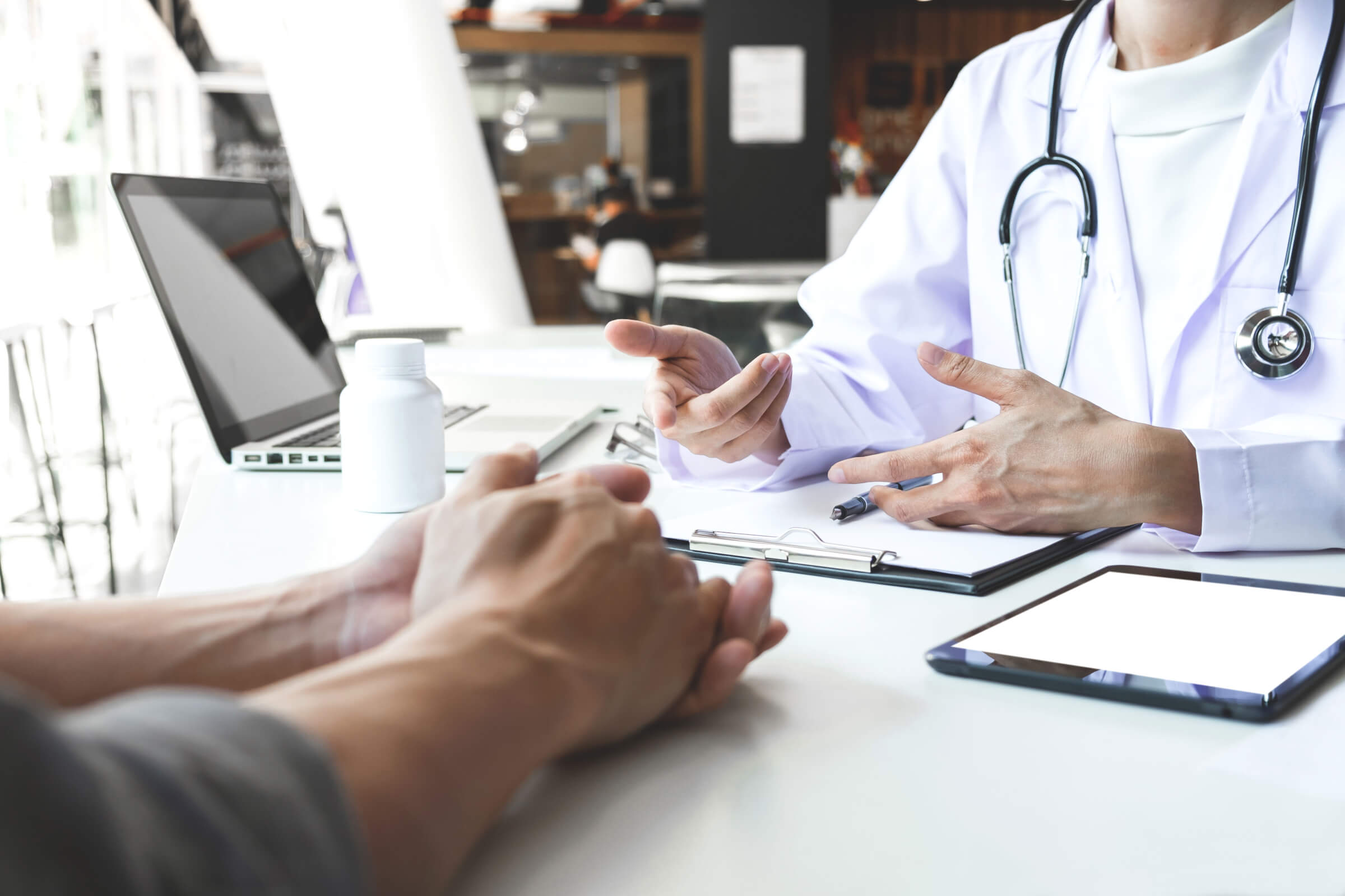 Medical professional discussing paperwork to an individual.